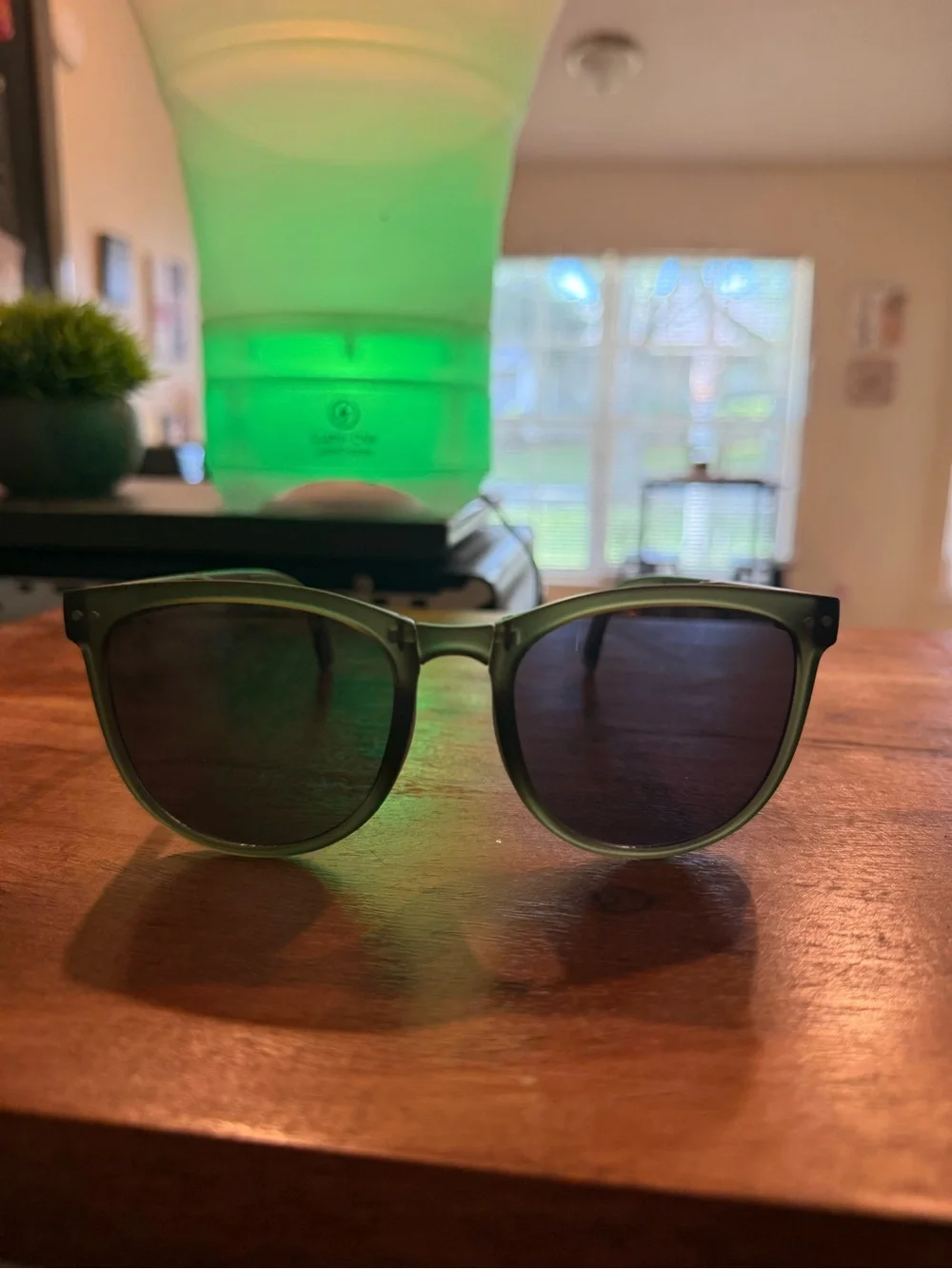 Green sunglasses with black lenses